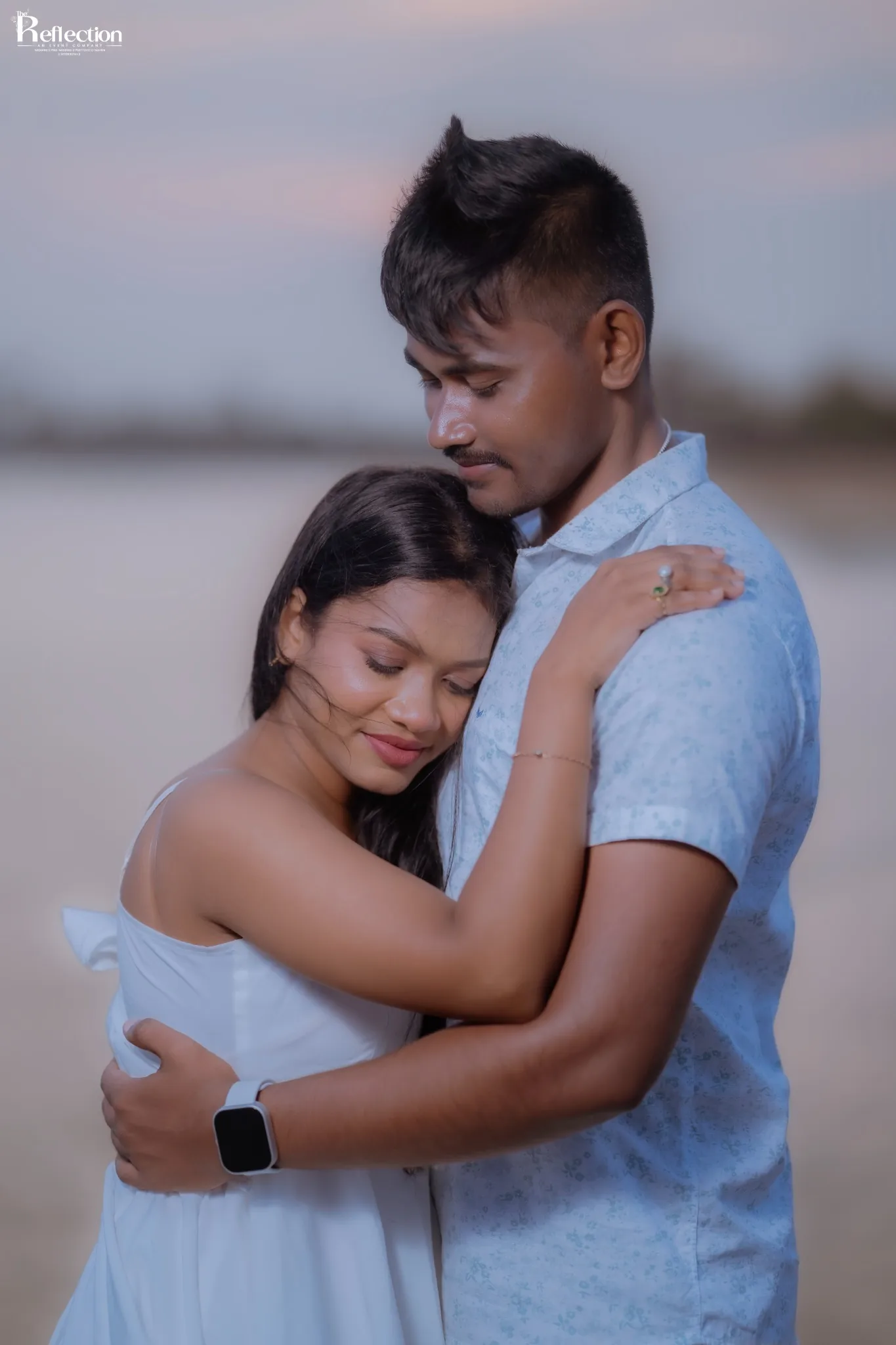 Couple embracing in a softly lit portrait