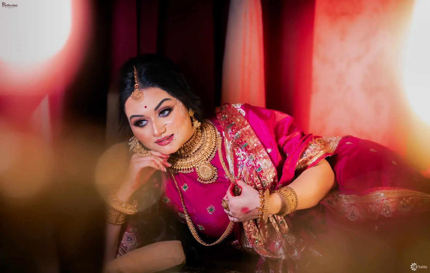 Editorial bridal portrait in a vibrant magenta sari