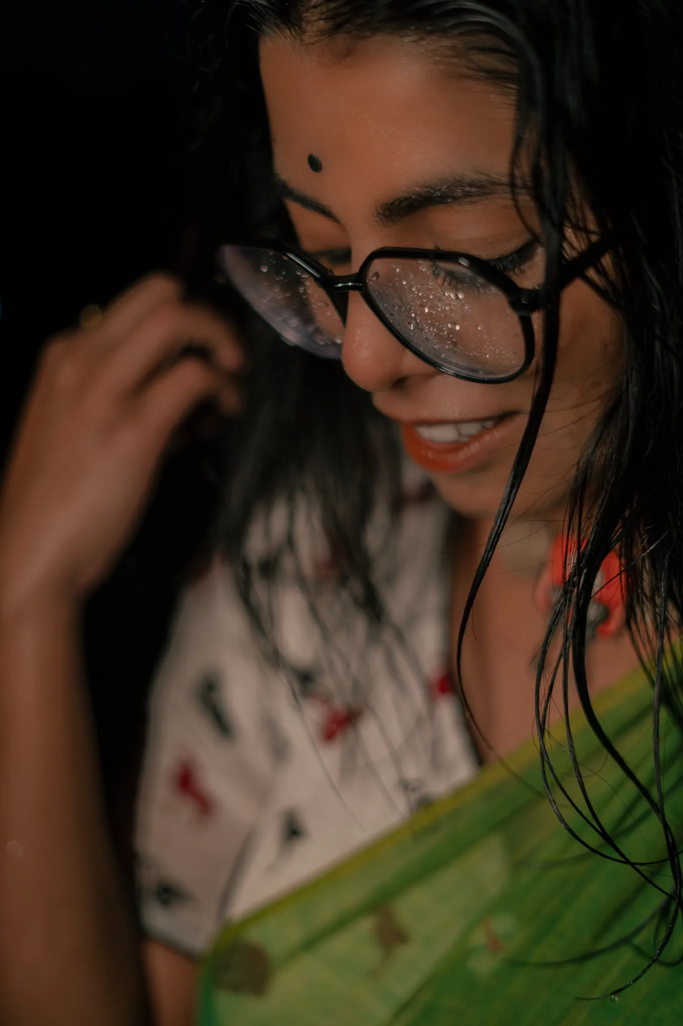 Expressive close-up portrait with glasses and rain on the lenses